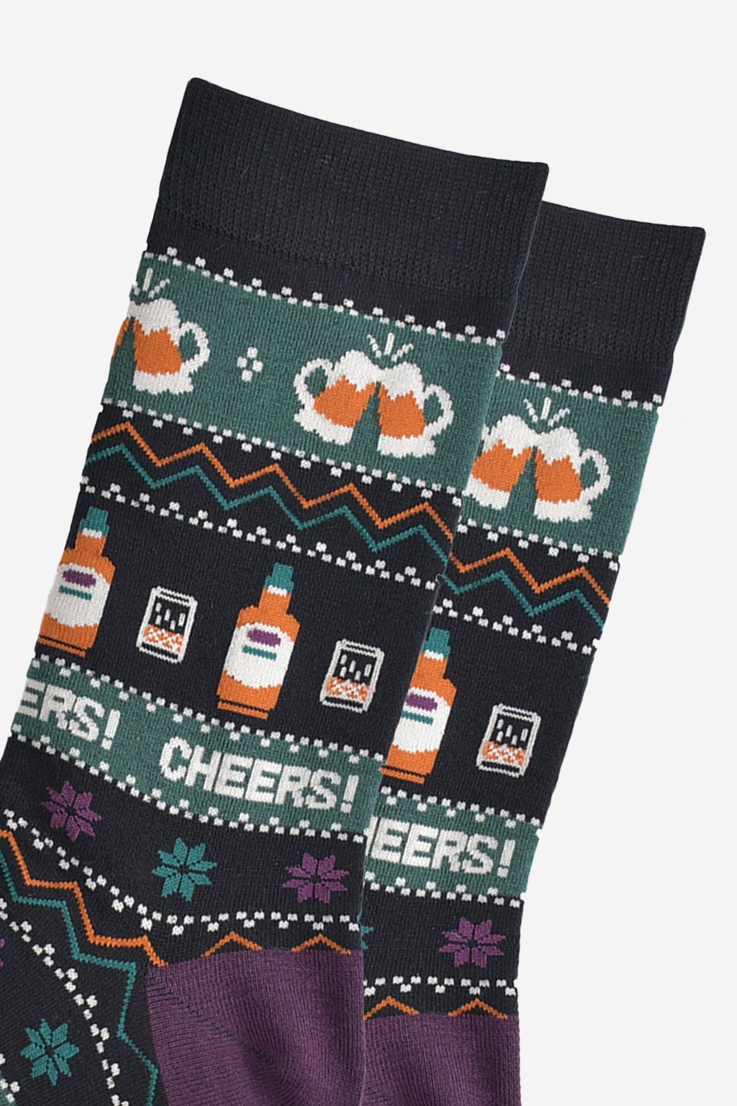 close up of the socks, showing clearly the beer glasses, whisky bottles and the fair isle pattern