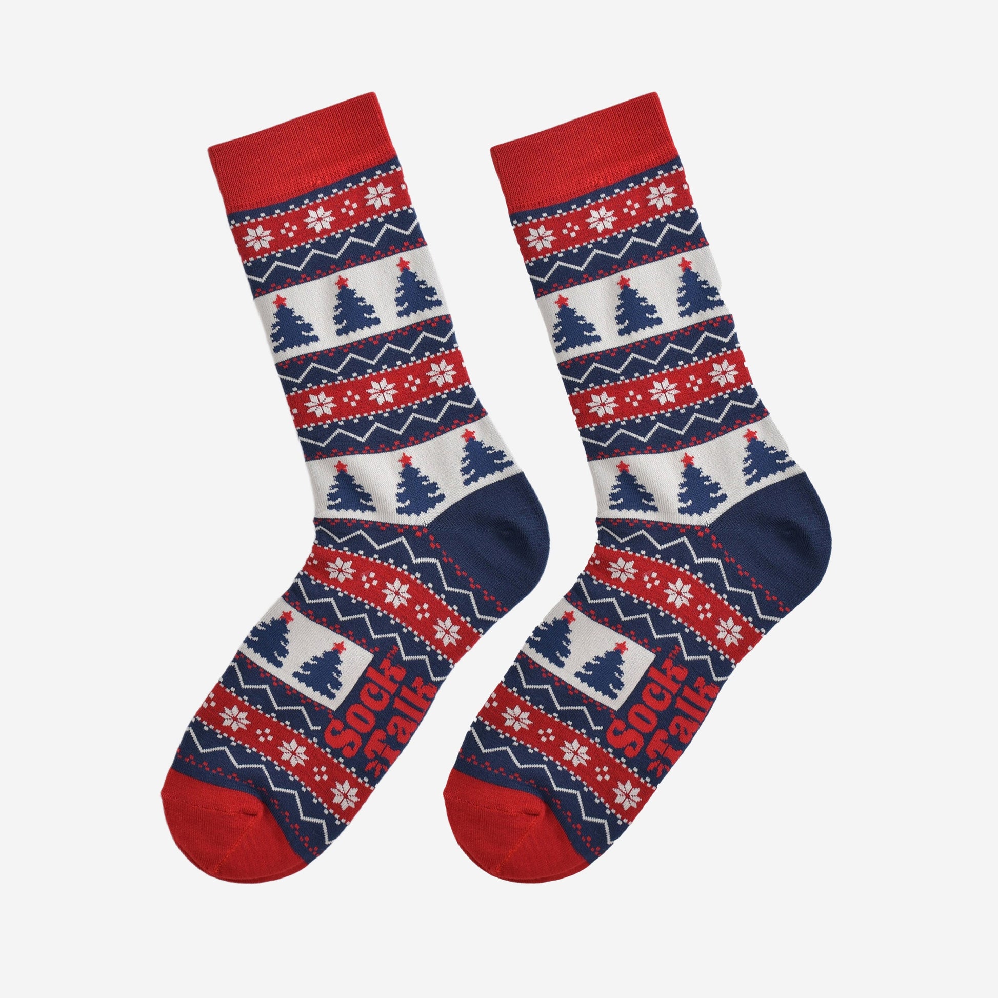 fair isle christmas tree socks laying flat, showing the all over pattern featuring snow flakes, xmas tress and zig zag patterns