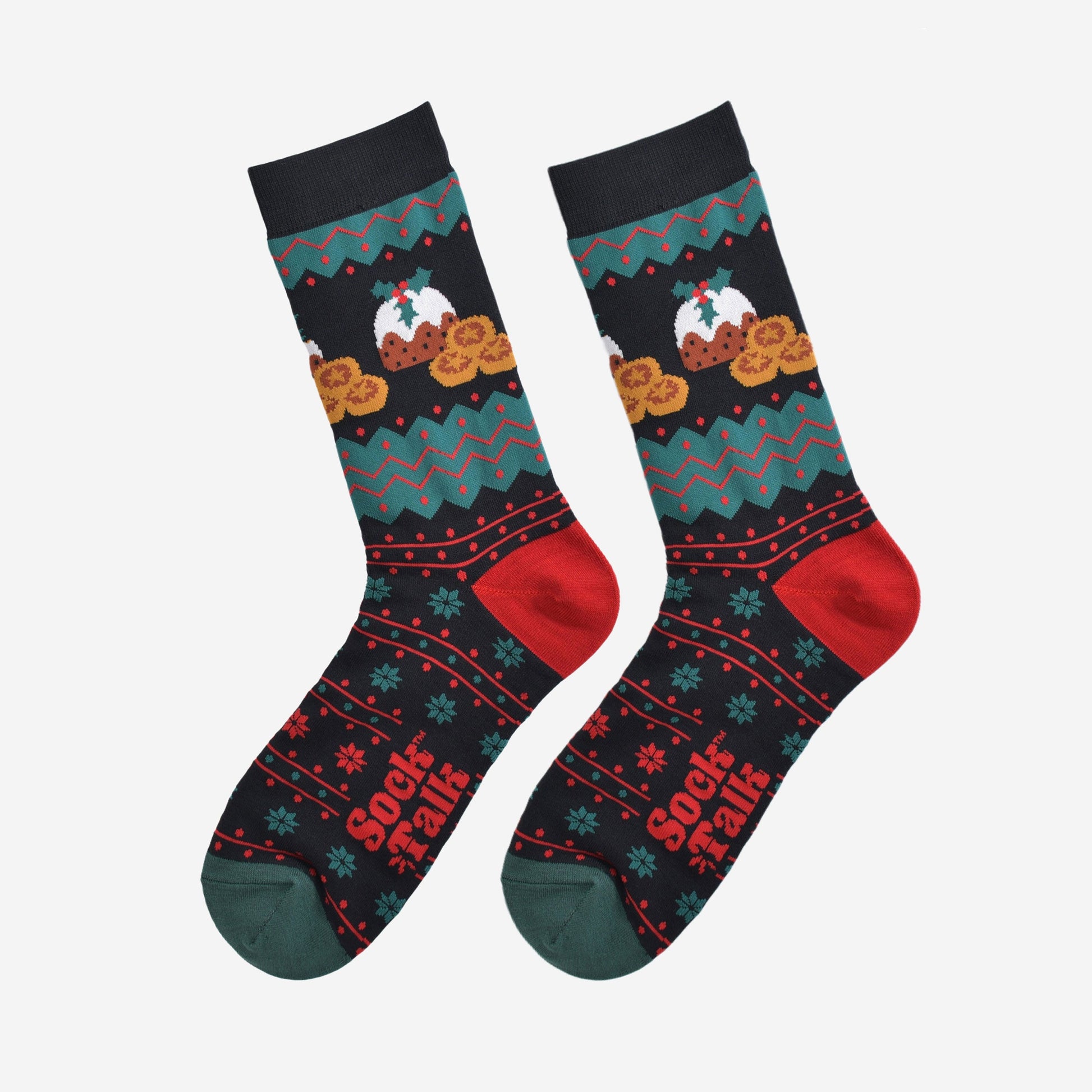 black, green and red fair isle style socks laying flat, showing the all over pattern and highlighting the christmas pudding and mince pie design on the ankle of the socks