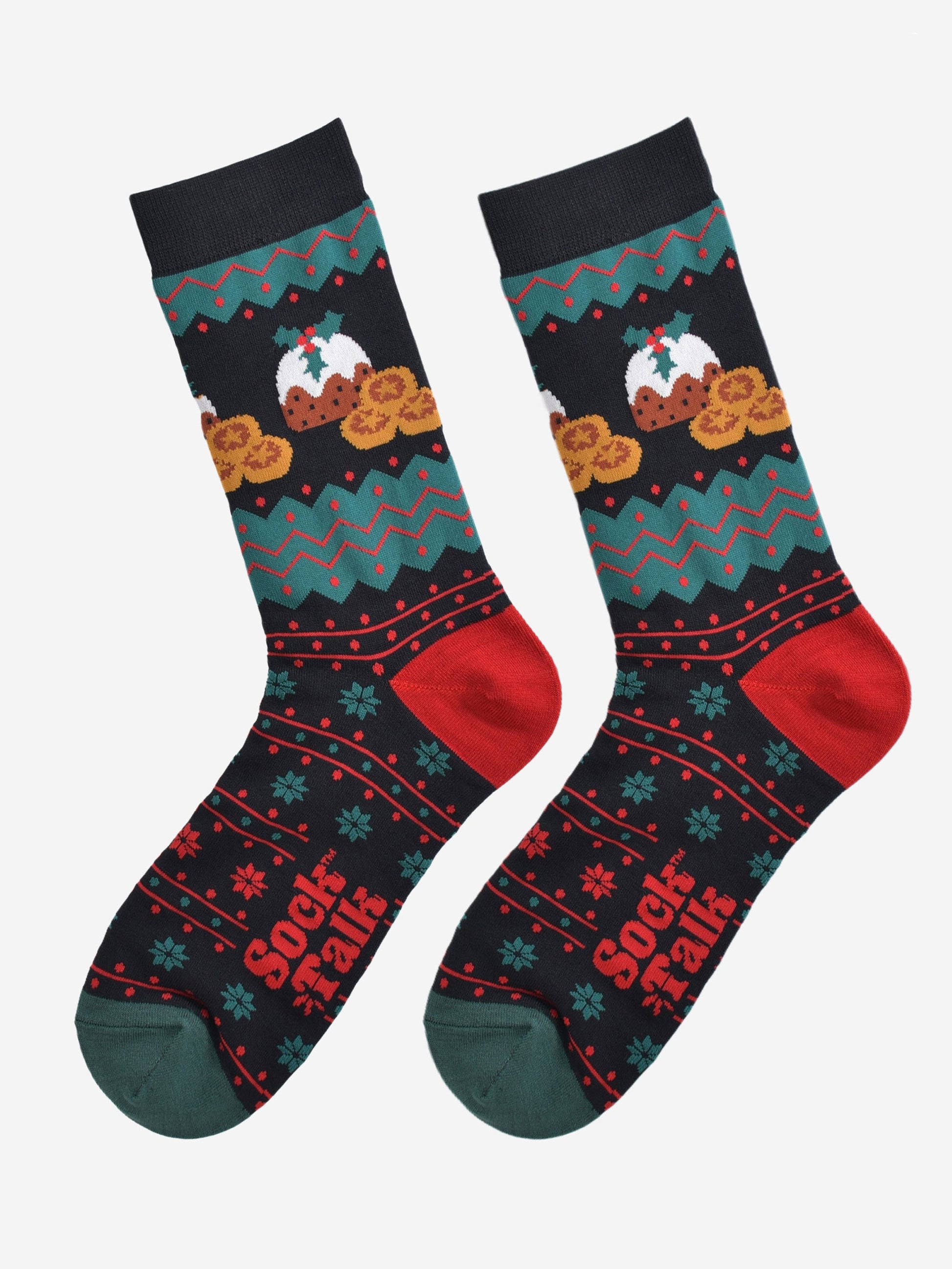black, green and red fair isle style socks laying flat, showing the all over pattern and highlighting the christmas pudding and mince pie design on the ankle of the socks