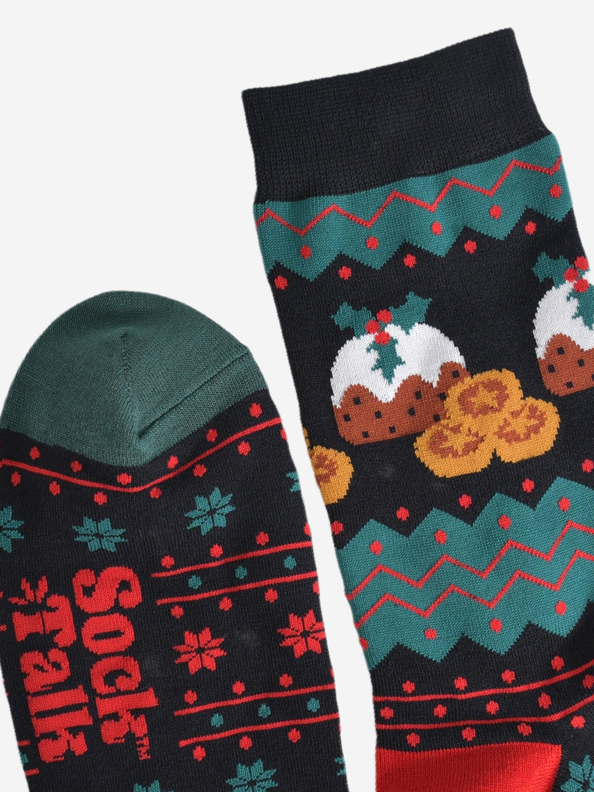 close up of the cuff and toe of the socks, the cuff is black and the toe is green, the fair isle pattern is shown clearly