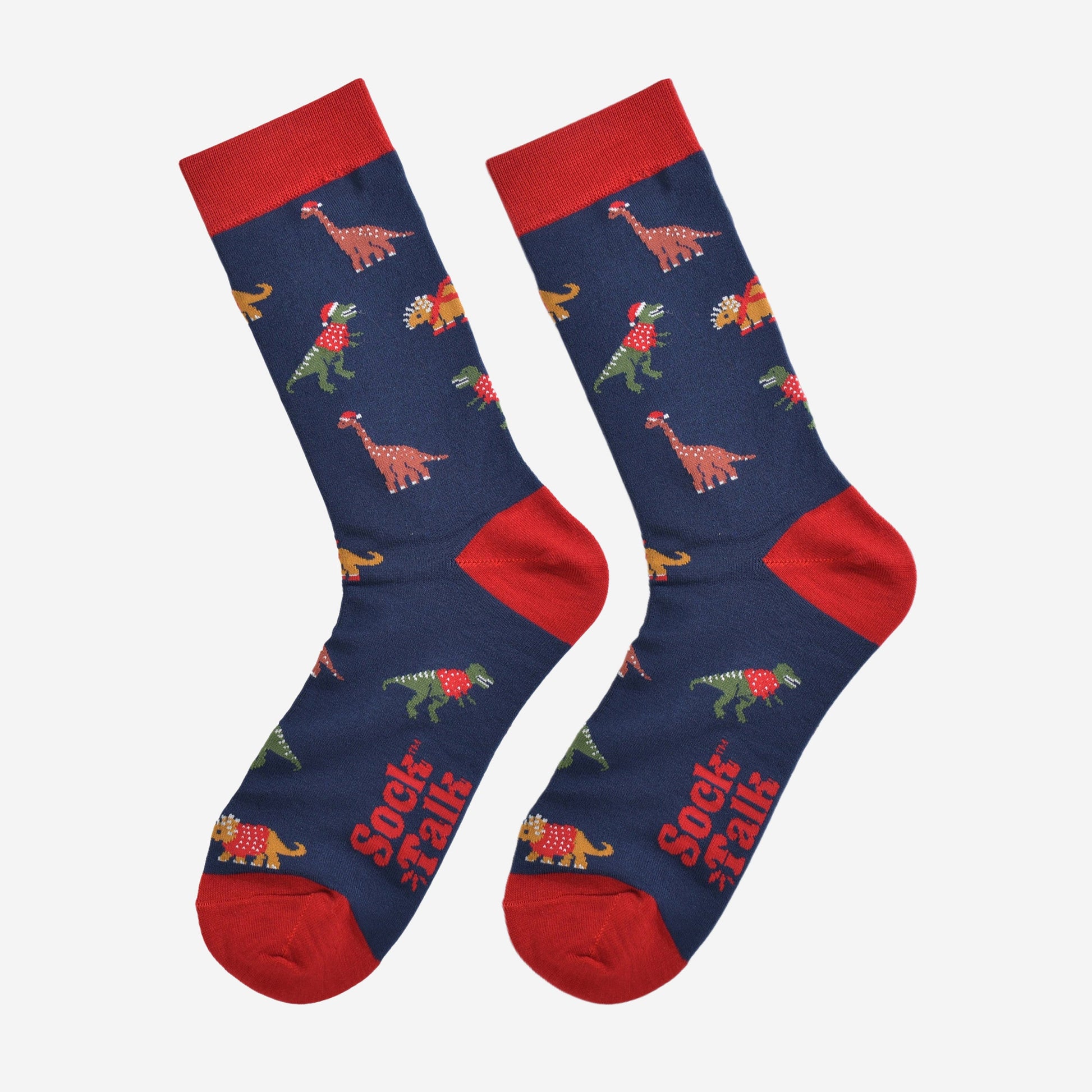 christmas dinosaur bamboo socks laying flat, showing the all over festive pattern of colourful dinosaurs wearing xmas hats and jumpers