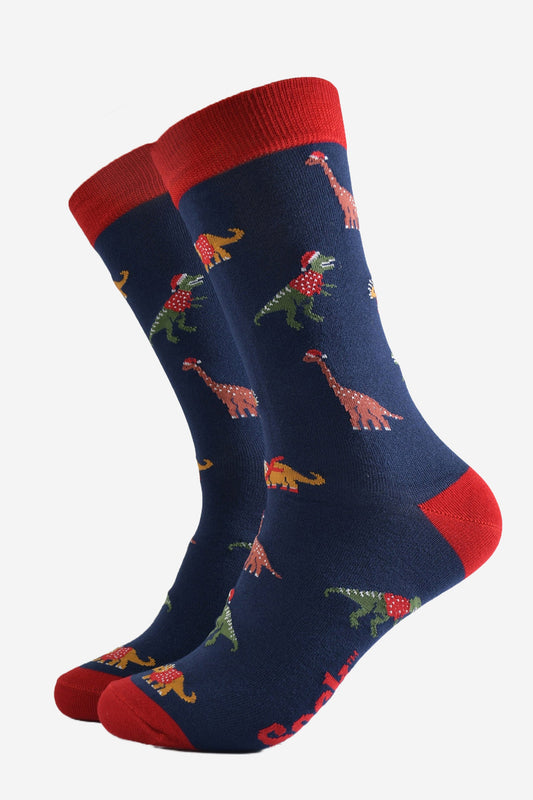 navy blue dress socks with a red heel, toe and cuff with a pattern of colourful dinosaurs wearing santa hats