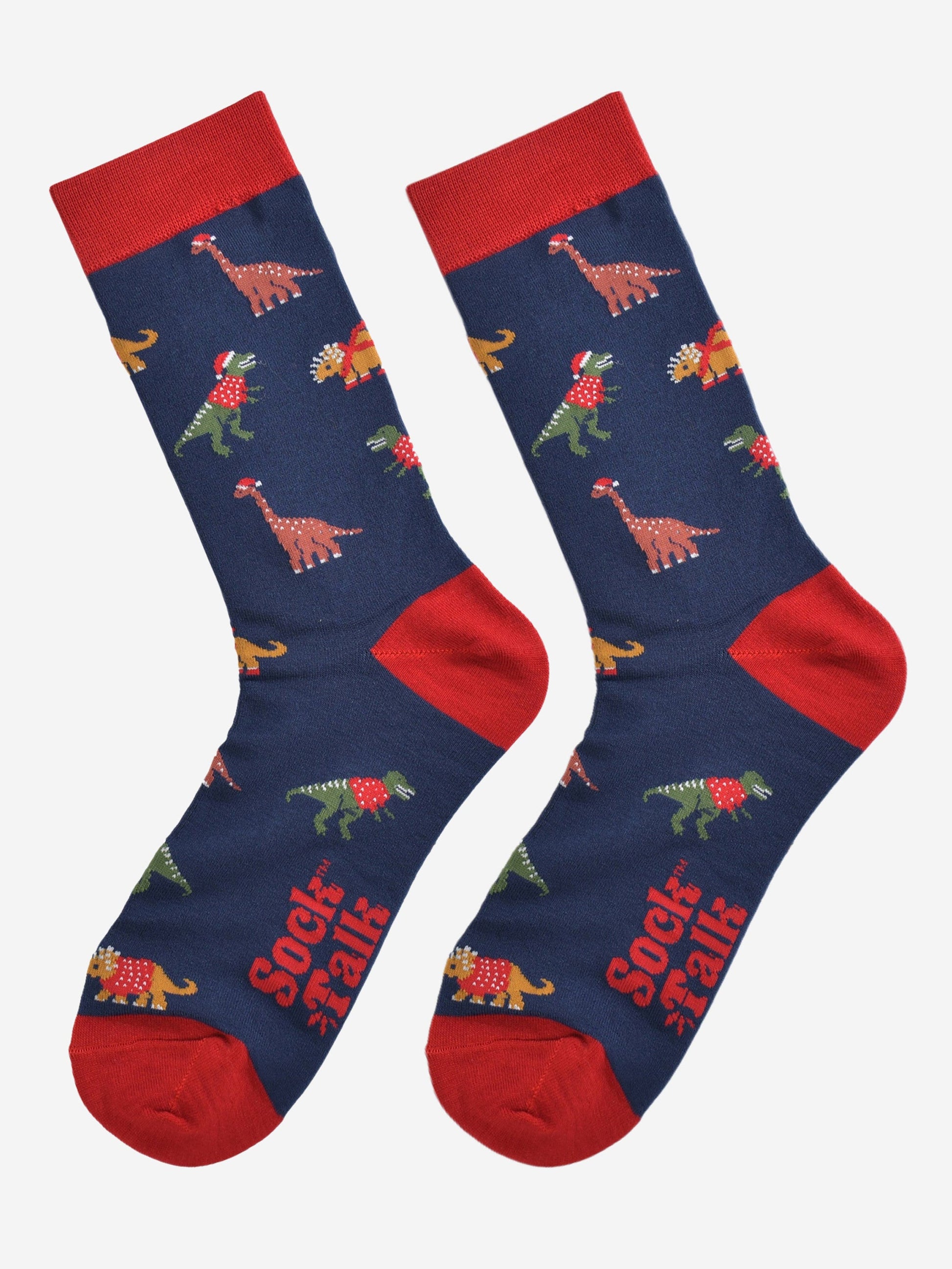 christmas dinosaur bamboo socks laying flat, showing the all over festive pattern of colourful dinosaurs wearing xmas hats and jumpers