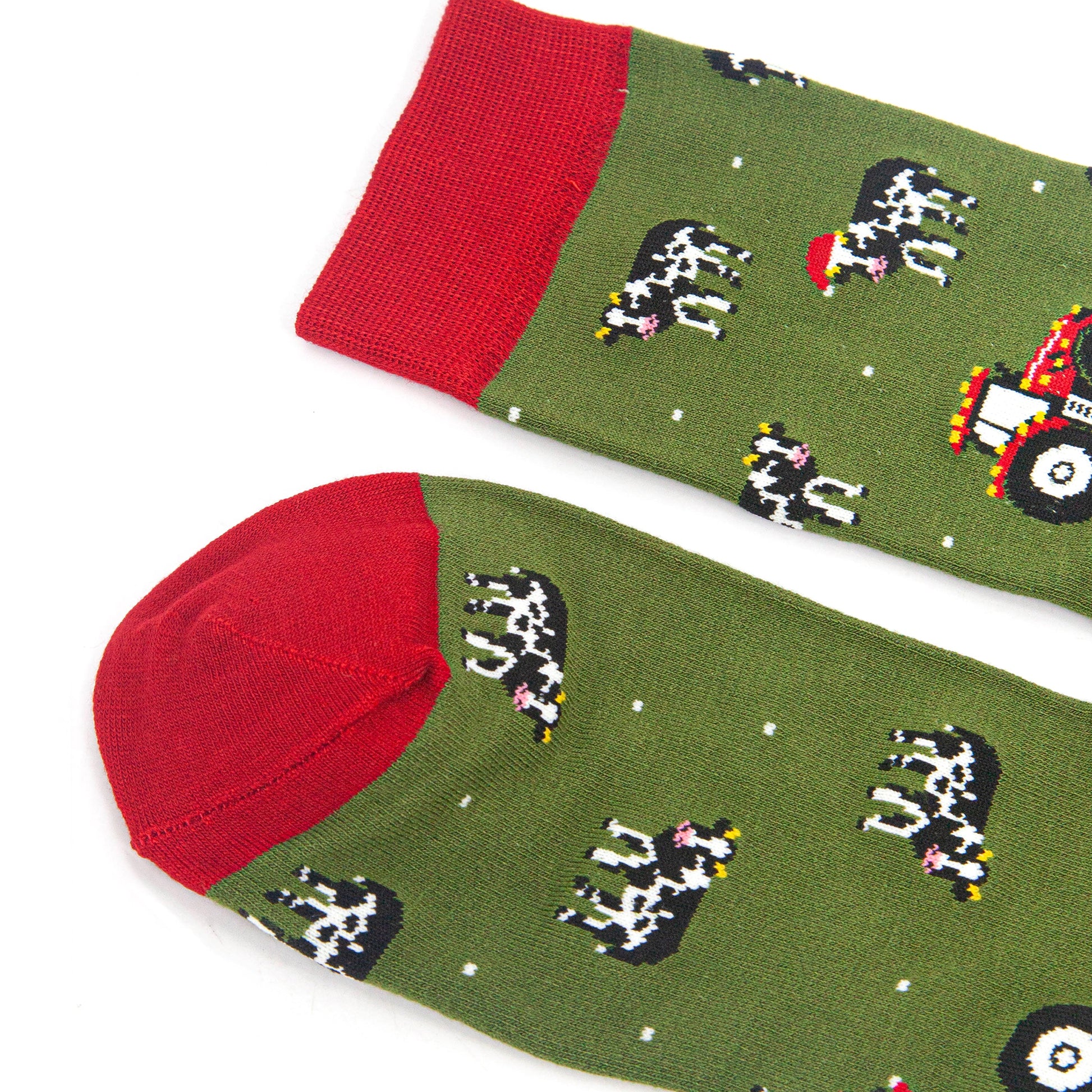 close up of the red heel and cuff on the socks, they contrast the green background of the design