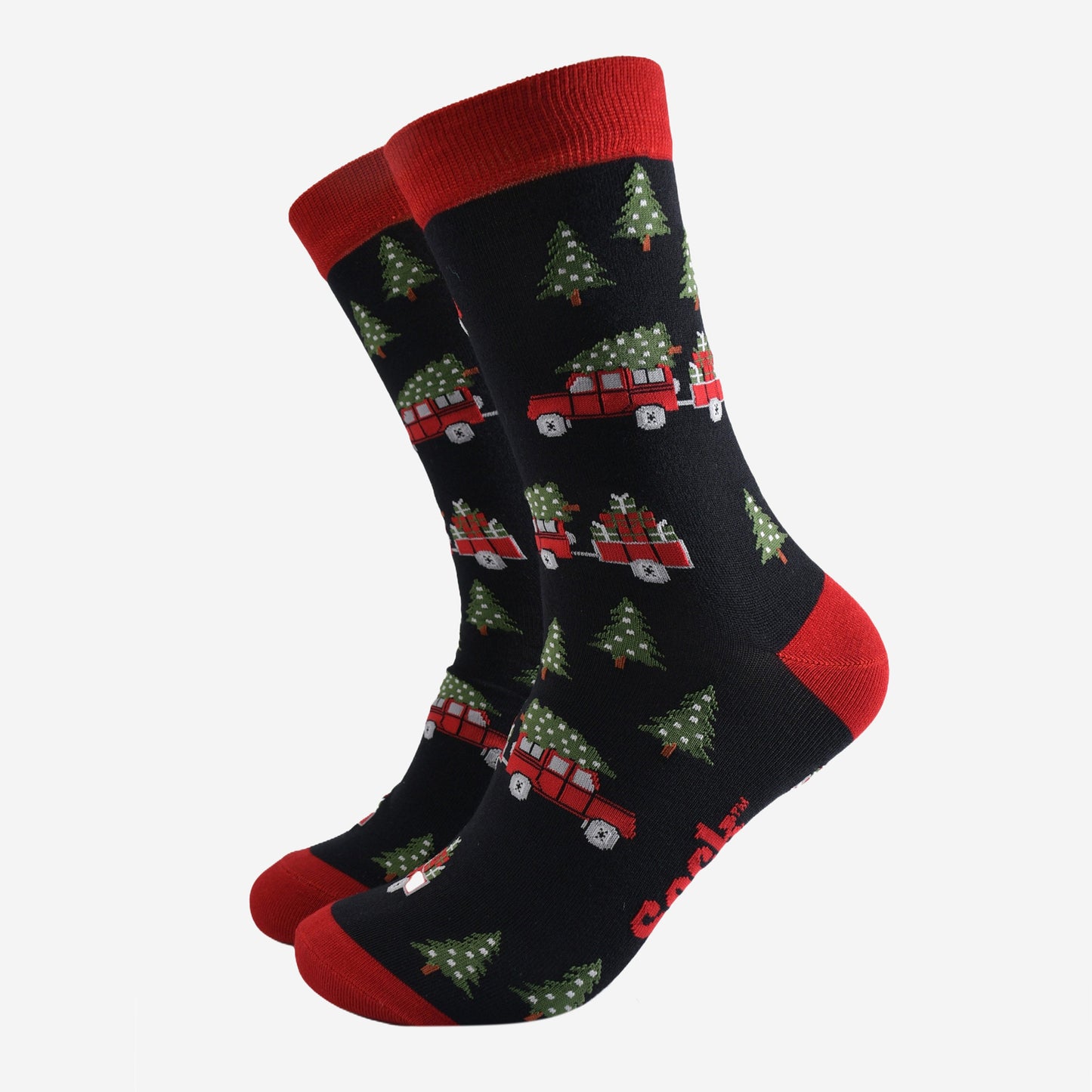 black socks with a pattern of red off road vehicles, xmas trees and Christmas gifts