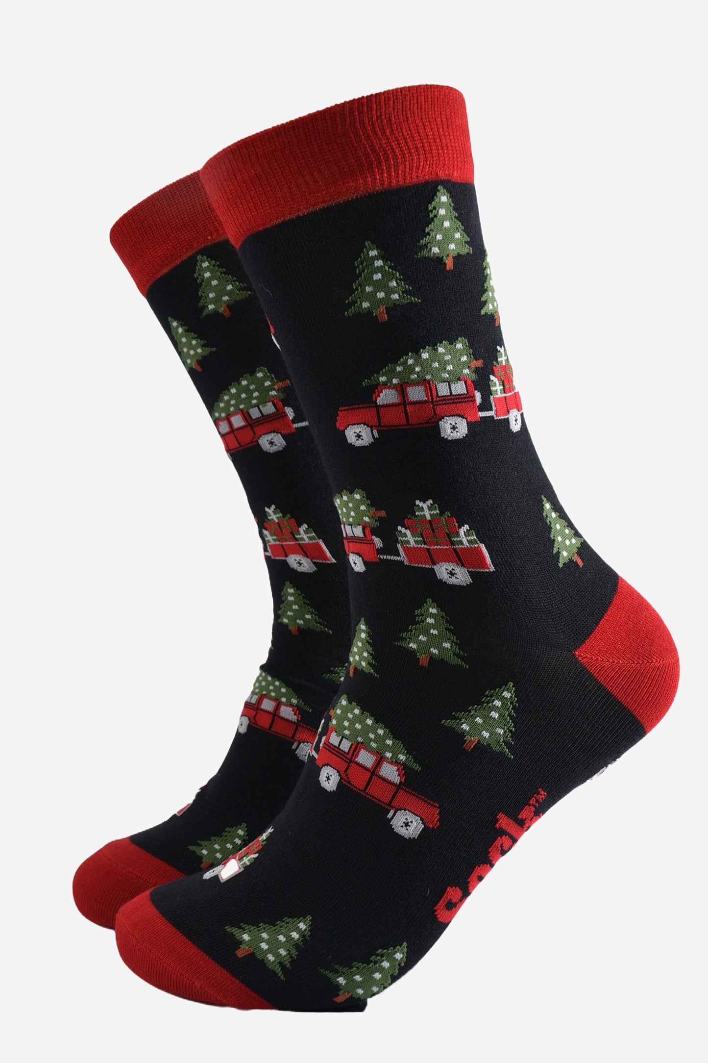 black socks with a pattern of red off road vehicles, xmas trees and Christmas gifts