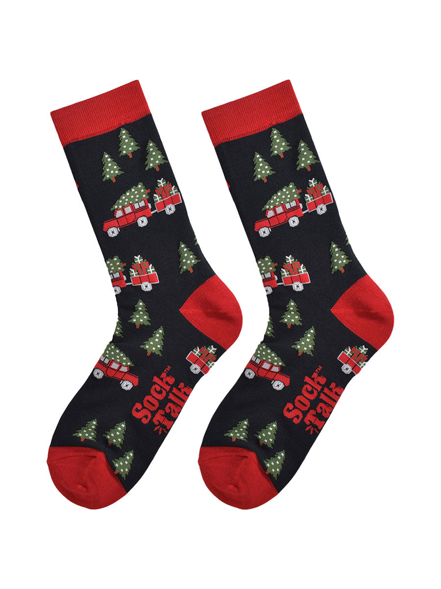 off road vehicle and christmas tree socks laying flat, showing the pattern clearly where the vehicle is towing a trailer full of xmas gifts