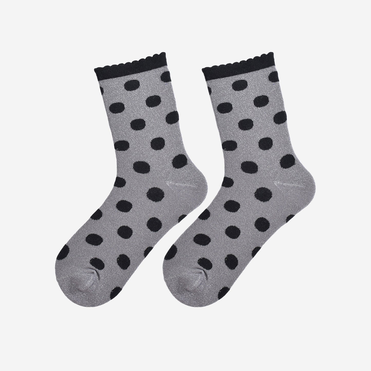 showing the grey and black polka dot socks laying flat, the silver glitter sparkle is visible and the black polka dot pattern is all over the design