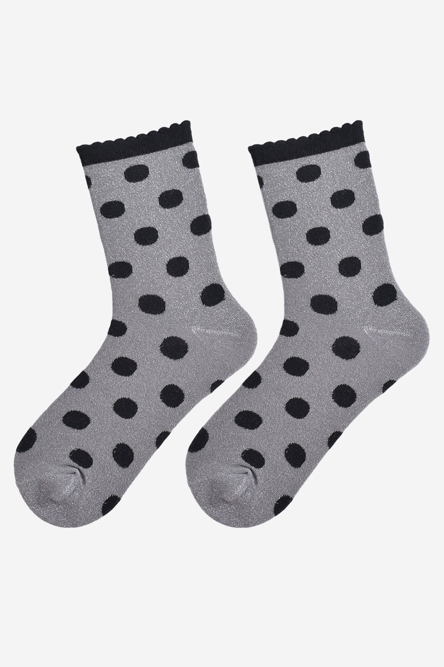 showing the grey and black polka dot socks laying flat, the silver glitter sparkle is visible and the black polka dot pattern is all over the design