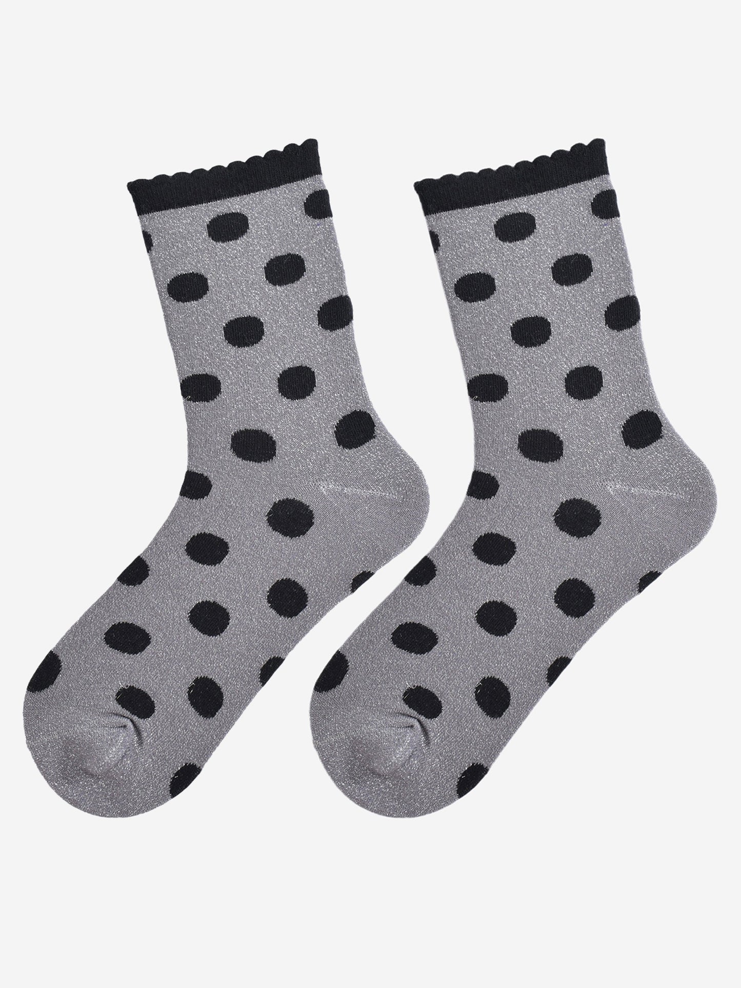 showing the grey and black polka dot socks laying flat, the silver glitter sparkle is visible and the black polka dot pattern is all over the design