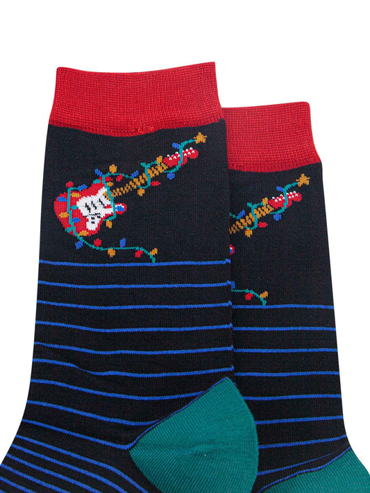 close up of the red electric guitar and multicoloured party lights on the ankle of the socks, the party lights are wrapped around the guitar