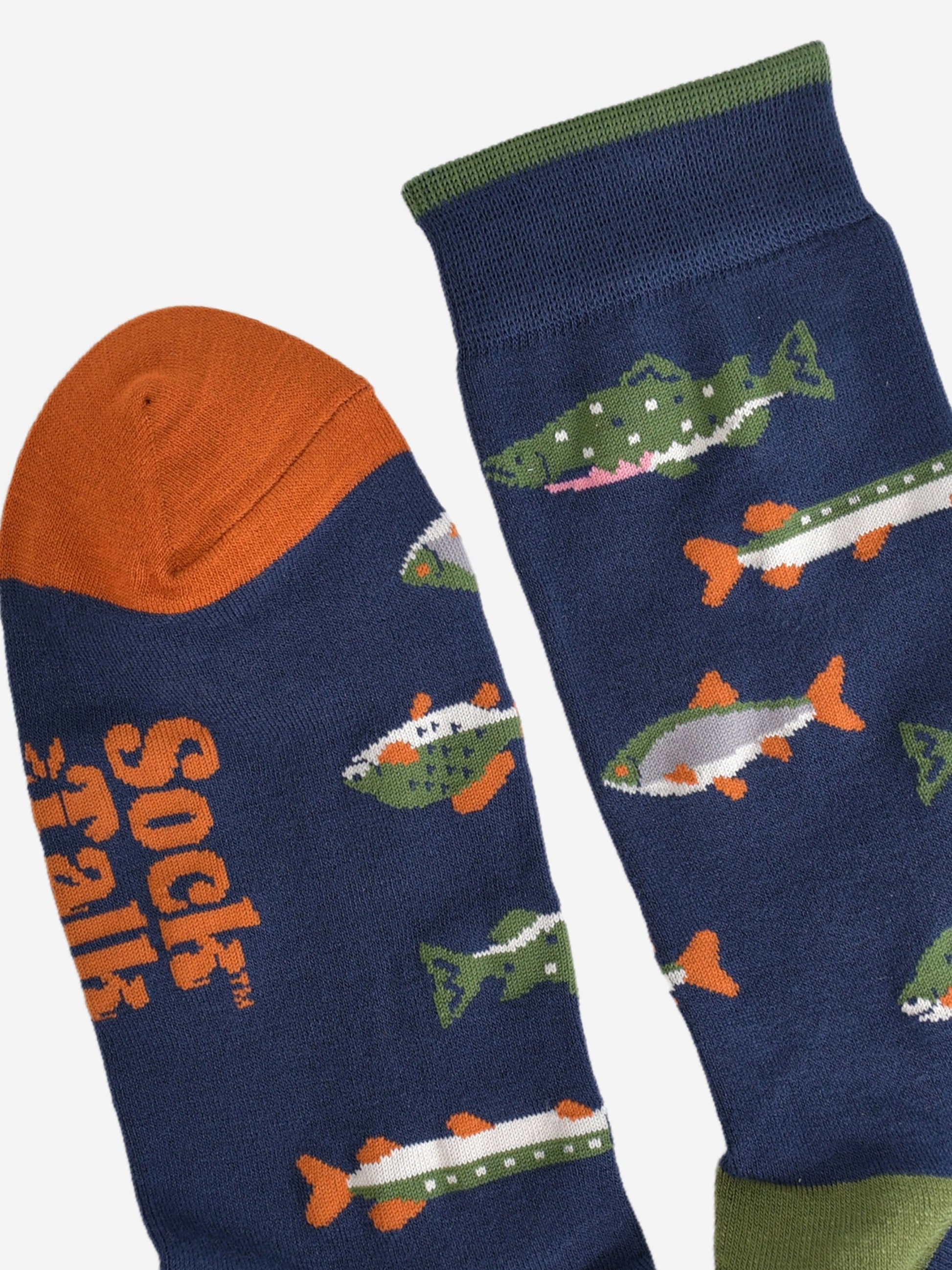 close up of the cuff and toe of the socks, the cuff has a thin green stripe on the edge and the toe is orange, both in contrast to the navy blue colour of the socks