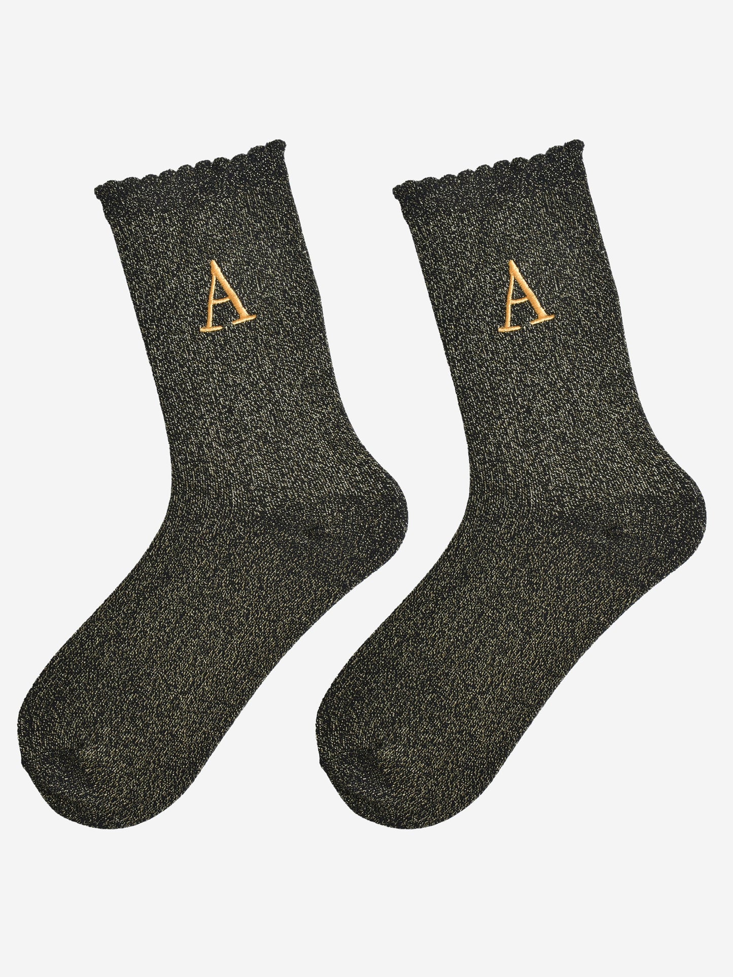 showing the glitter socks laying flat, they have a scalloped cuff and an all over gold sparkle