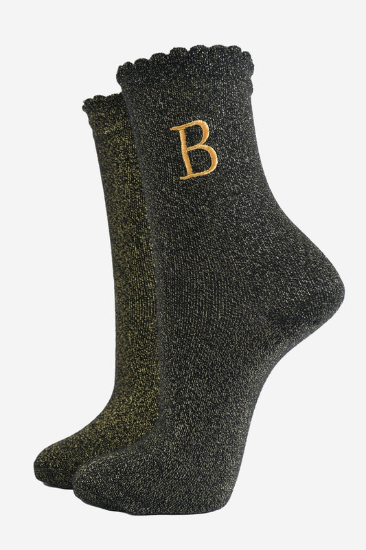 black ankle socks with a scalloped cuff, with an all over gold glitter sparkle and an embroidered gold letter b on the ankle