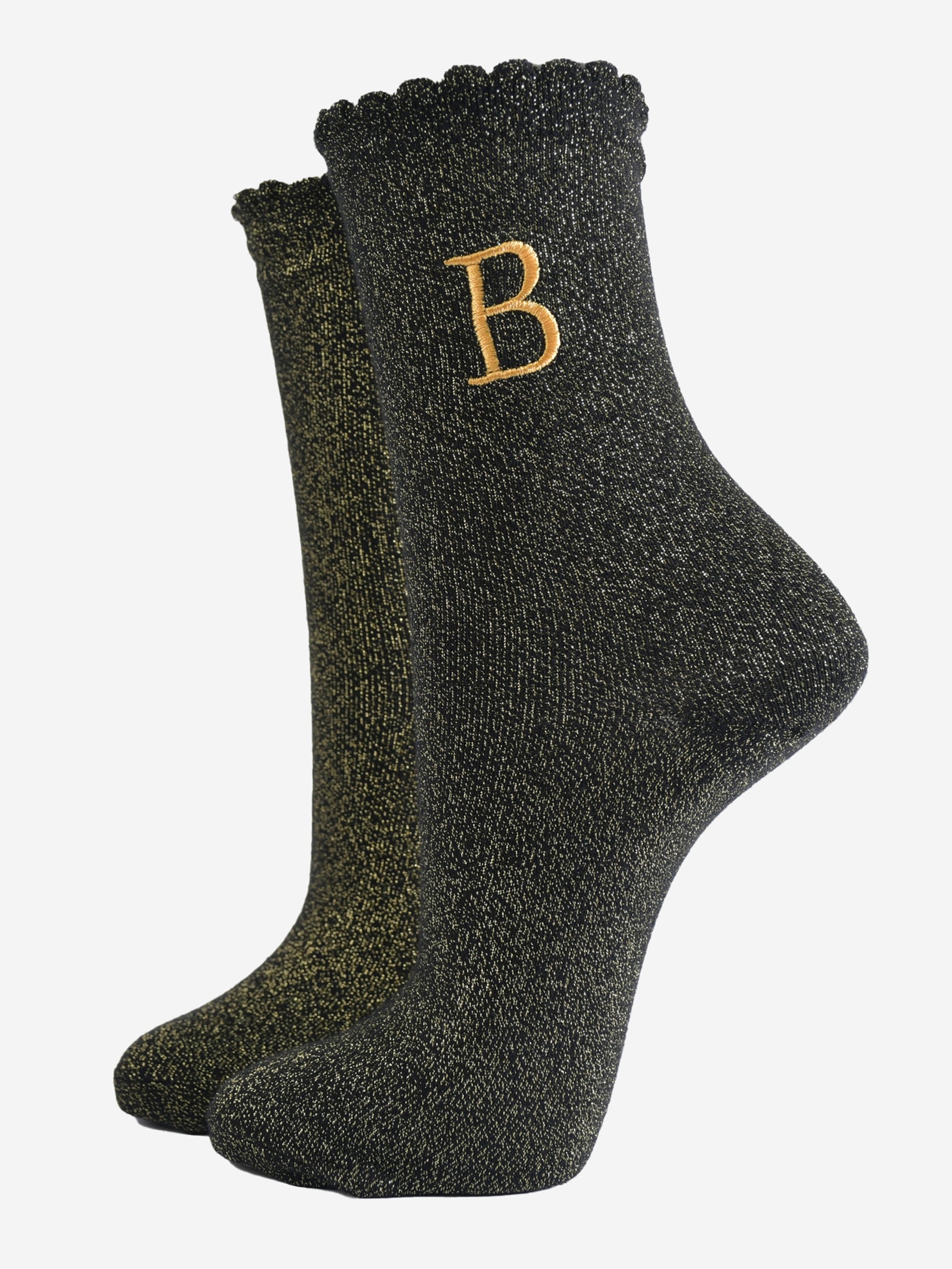 black ankle socks with a scalloped cuff, with an all over gold glitter sparkle and an embroidered gold letter b on the ankle