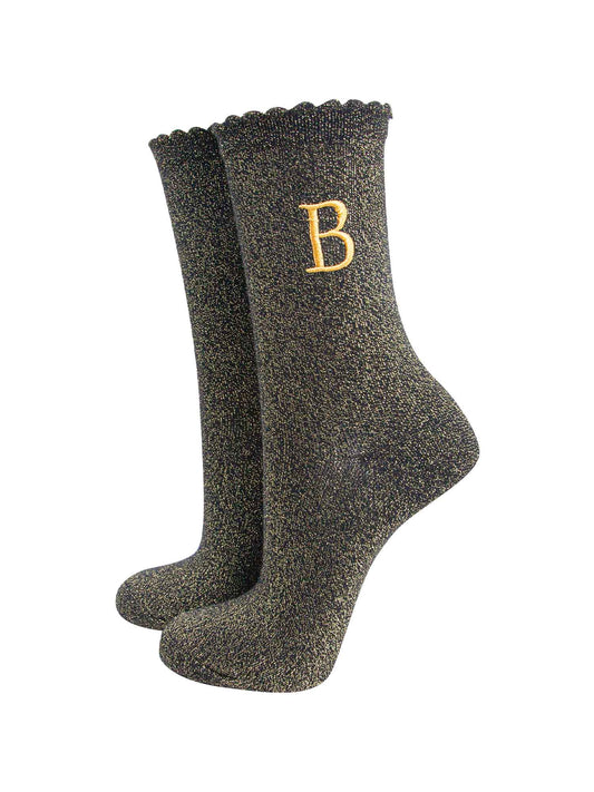 black ankle socks with a scalloped cuff, with an all over gold glitter sparkle and an embroidered gold letter b on the ankle