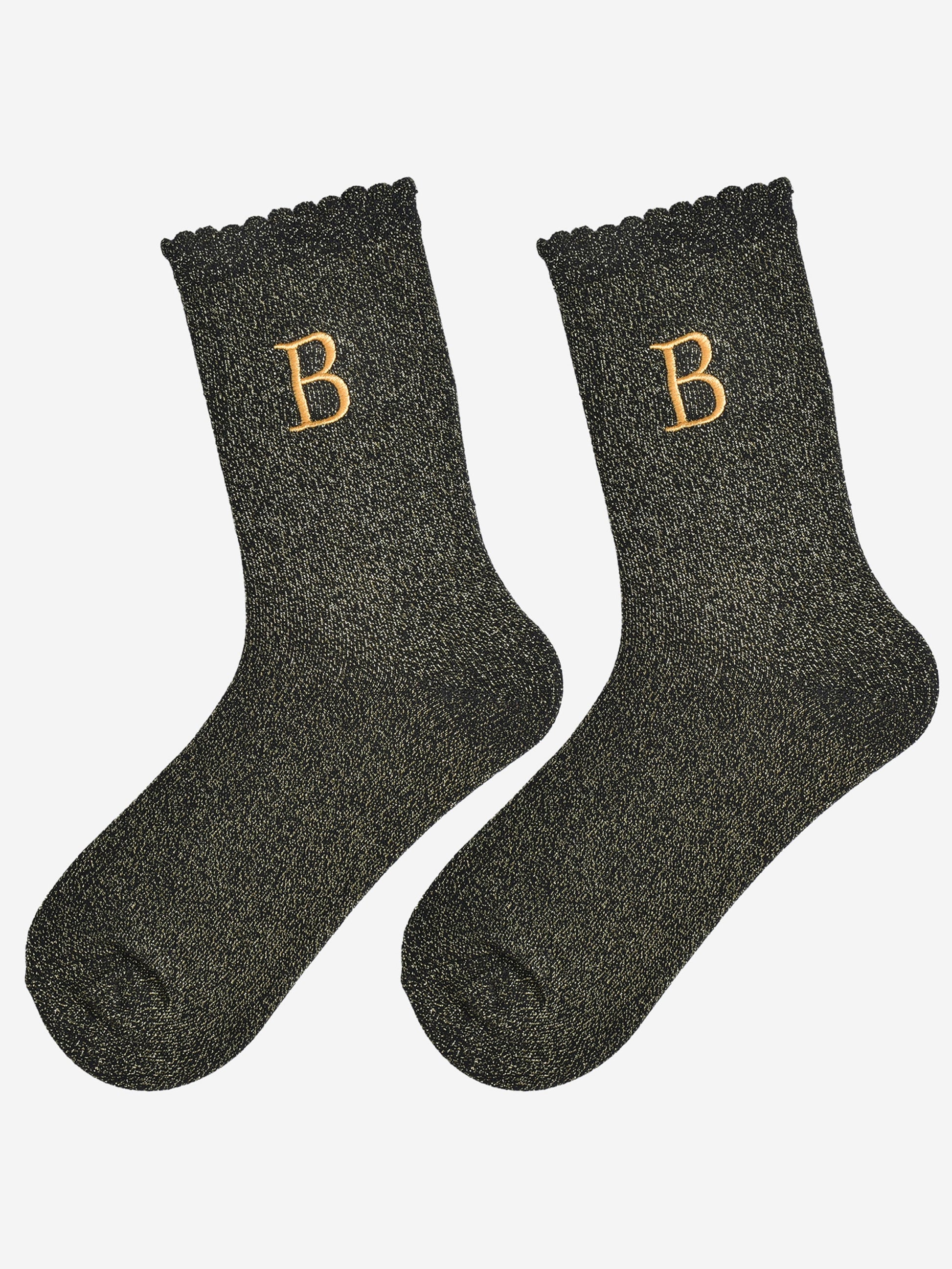 showing the glitter socks laying flat, they have a scalloped cuff and an all over gold sparkle