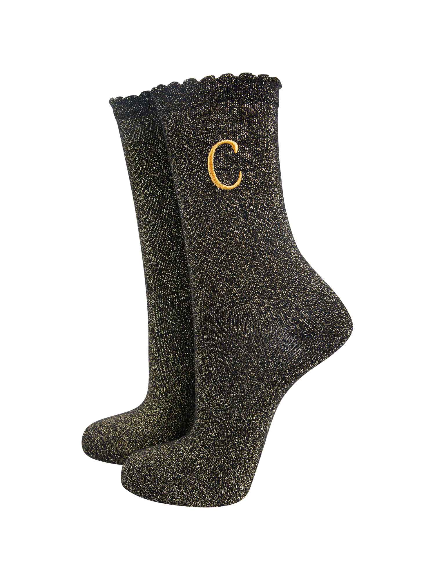 black ankle socks with a scalloped cuff, with an all over gold glitter sparkle and an embroidered gold letter c on the ankle