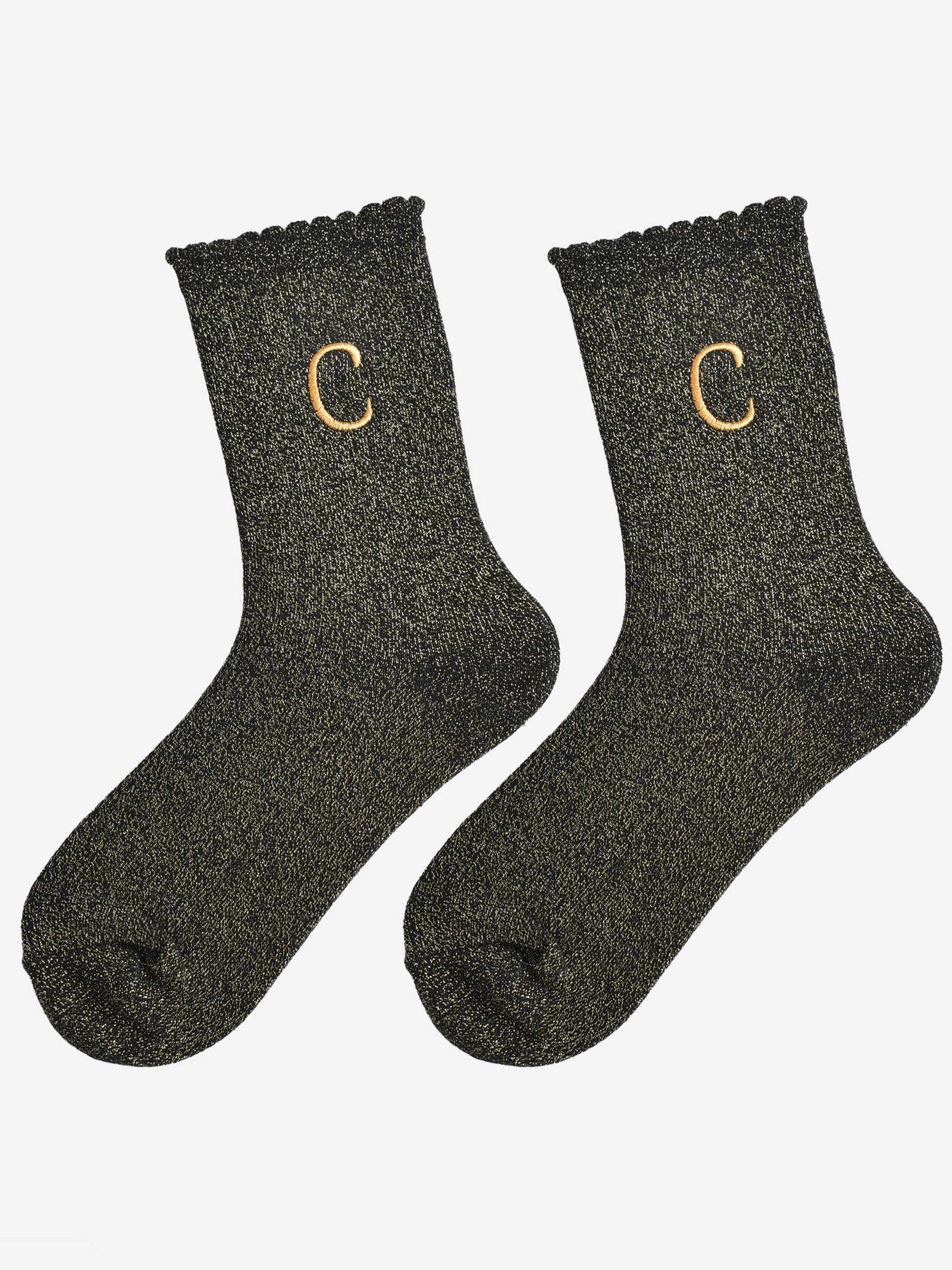 showing the glitter socks laying flat, they have a scalloped cuff and an all over gold sparkle