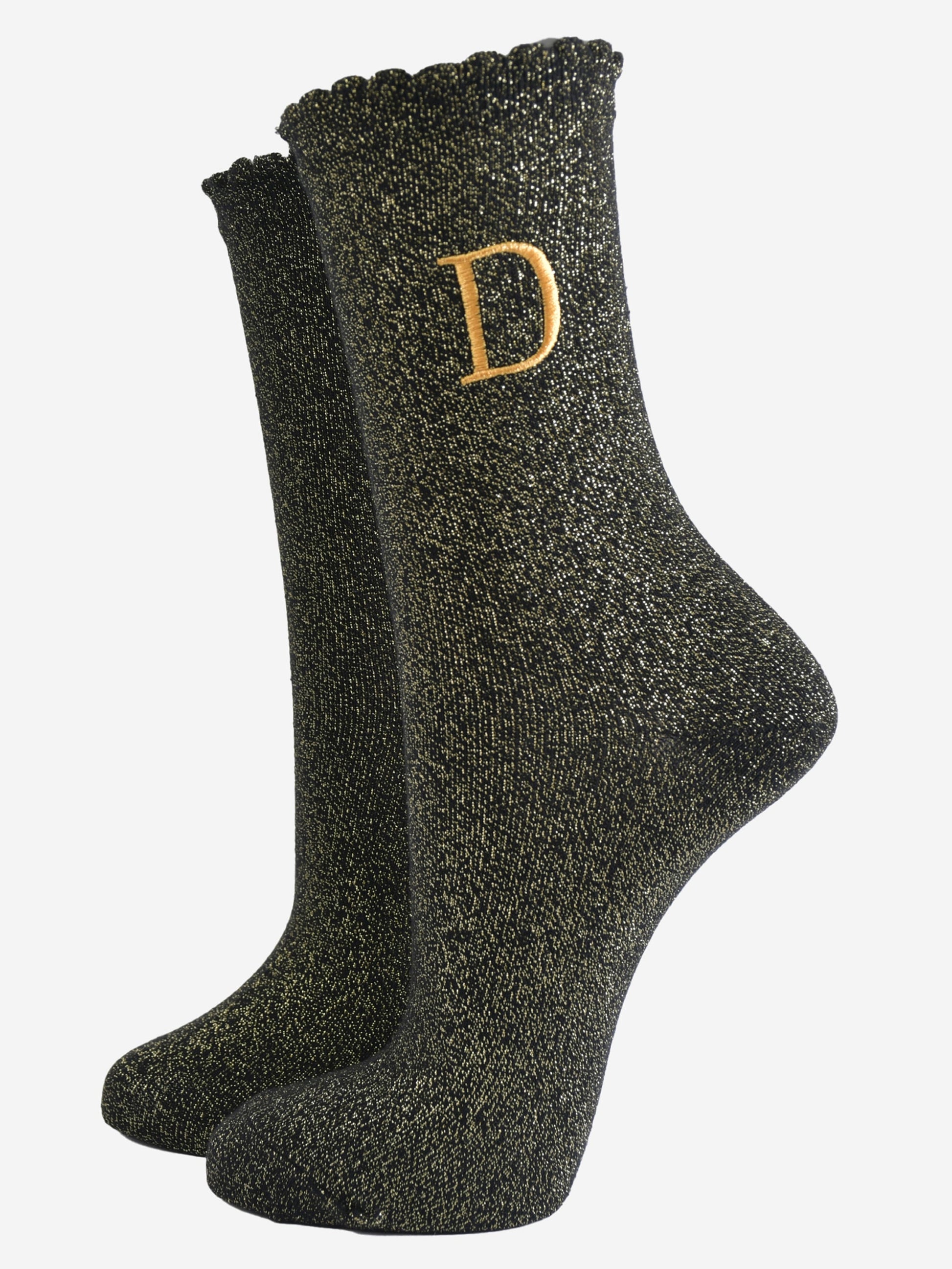 black ankle socks with a scalloped cuff, with an all over gold glitter sparkle and an embroidered gold letter d on the ankle
