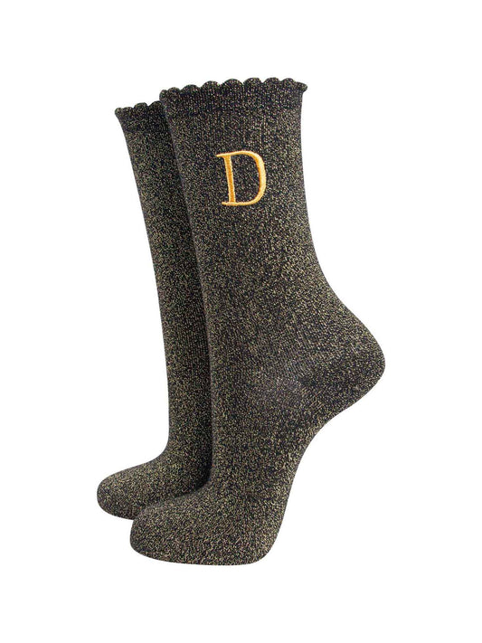 black ankle socks with a scalloped cuff, with an all over gold glitter sparkle and an embroidered gold letter d on the ankle