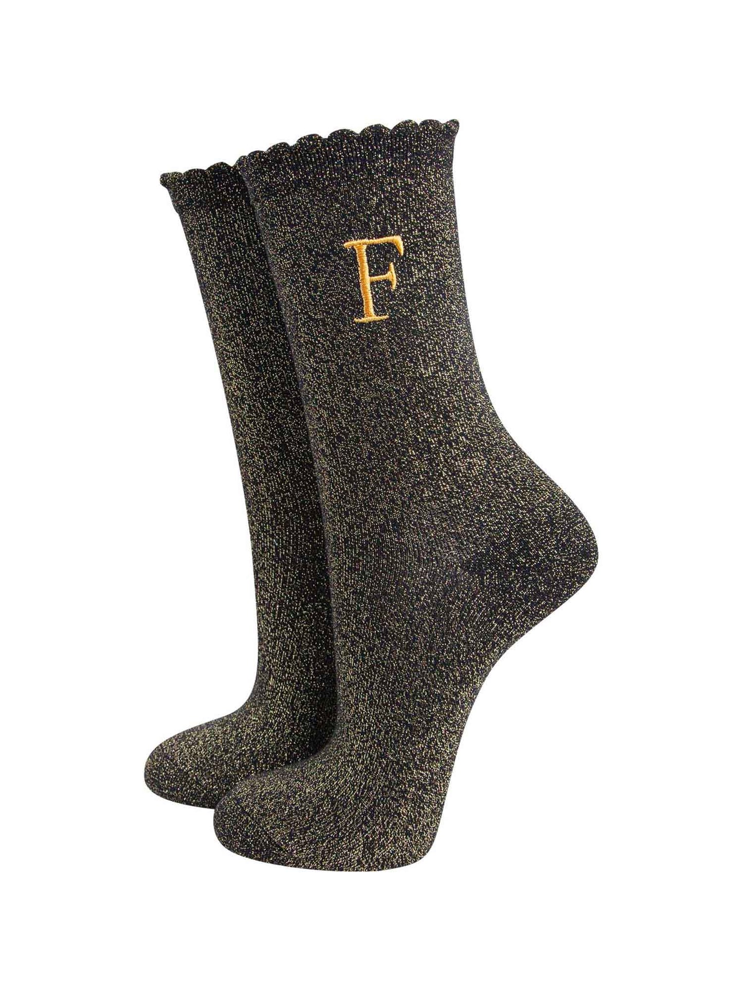 black ankle socks with a scalloped cuff, with an all over gold glitter sparkle and an embroidered gold letter f on the ankle