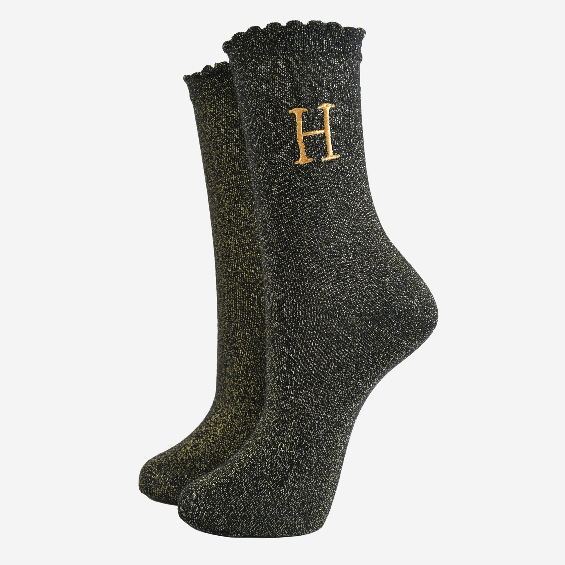 black ankle socks with a scalloped cuff, with an all over gold glitter sparkle and an embroidered gold letter h on the ankle