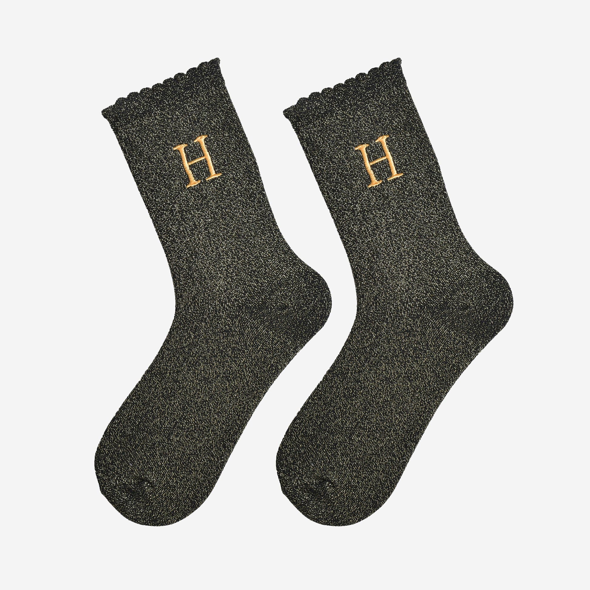 showing the glitter socks laying flat, they have a scalloped cuff and an all over gold sparkle