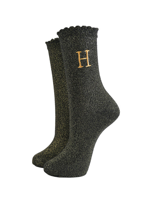 black ankle socks with a scalloped cuff, with an all over gold glitter sparkle and an embroidered gold letter h on the ankle