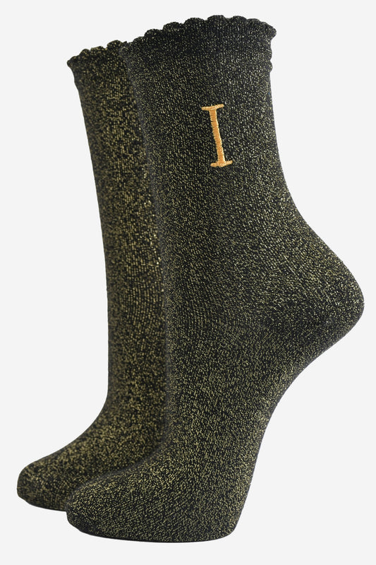 black ankle socks with a scalloped cuff, with an all over gold glitter sparkle and an embroidered gold letter i on the ankle