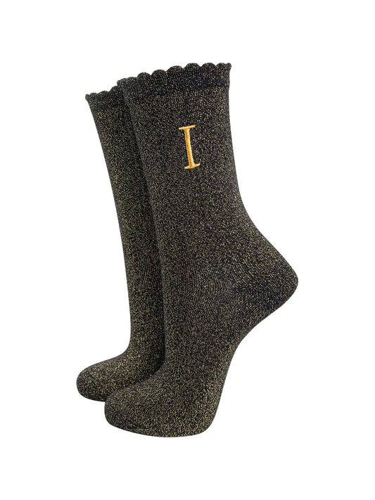 black ankle socks with a scalloped cuff, with an all over gold glitter sparkle and an embroidered gold letter i on the ankle
