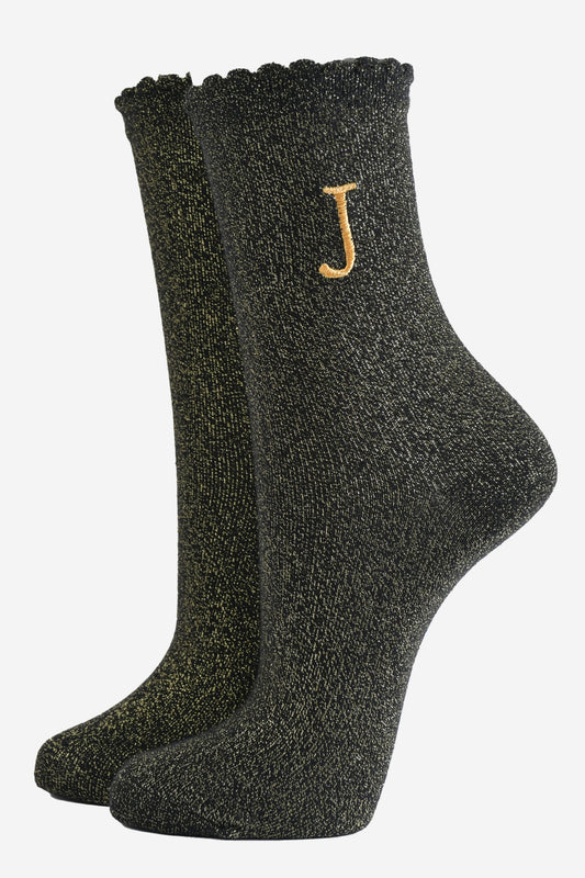 black ankle socks with a scalloped cuff, with an all over gold glitter sparkle and an embroidered gold letter j on the ankle