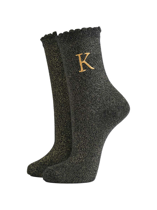 black ankle socks with a scalloped cuff, with an all over gold glitter sparkle and an embroidered gold letter k on the ankle