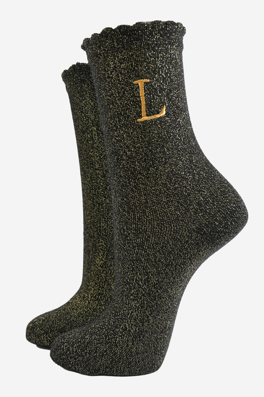 black ankle socks with a scalloped cuff, with an all over gold glitter sparkle and an embroidered gold letter l on the ankle