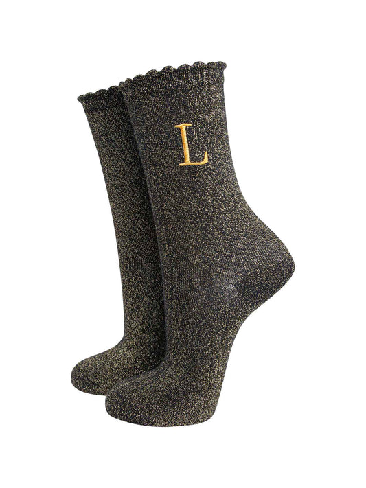 black ankle socks with a scalloped cuff, with an all over gold glitter sparkle and an embroidered gold letter l on the ankle