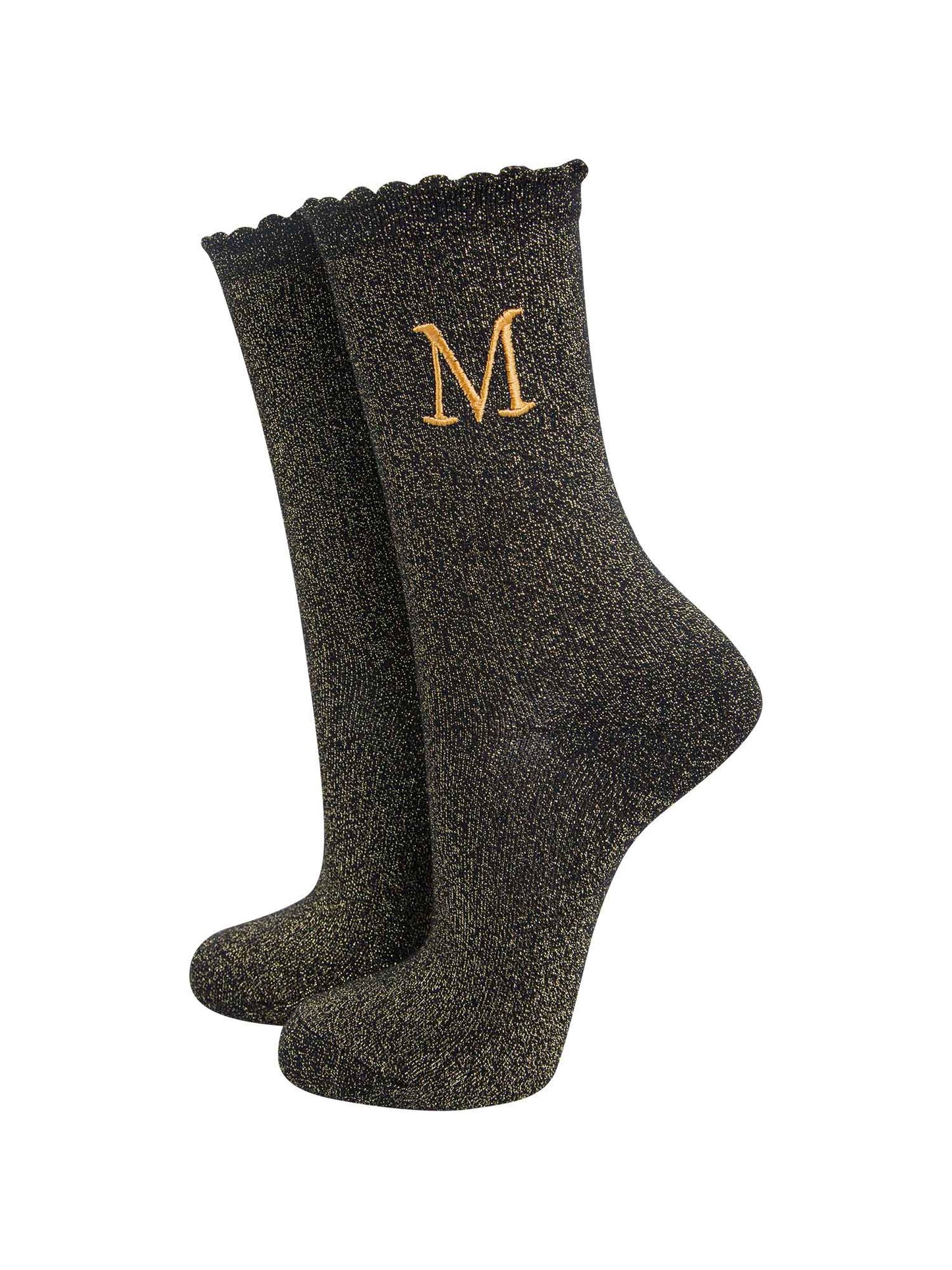 black ankle socks with a scalloped cuff, with an all over gold glitter sparkle and an embroidered gold letter m on the ankle