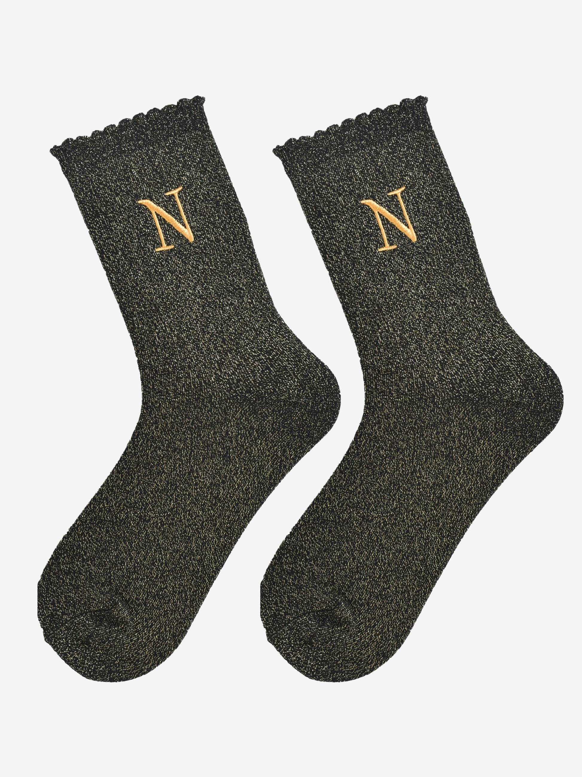 showing the glitter socks laying flat, they have a scalloped cuff and an all over gold sparkle