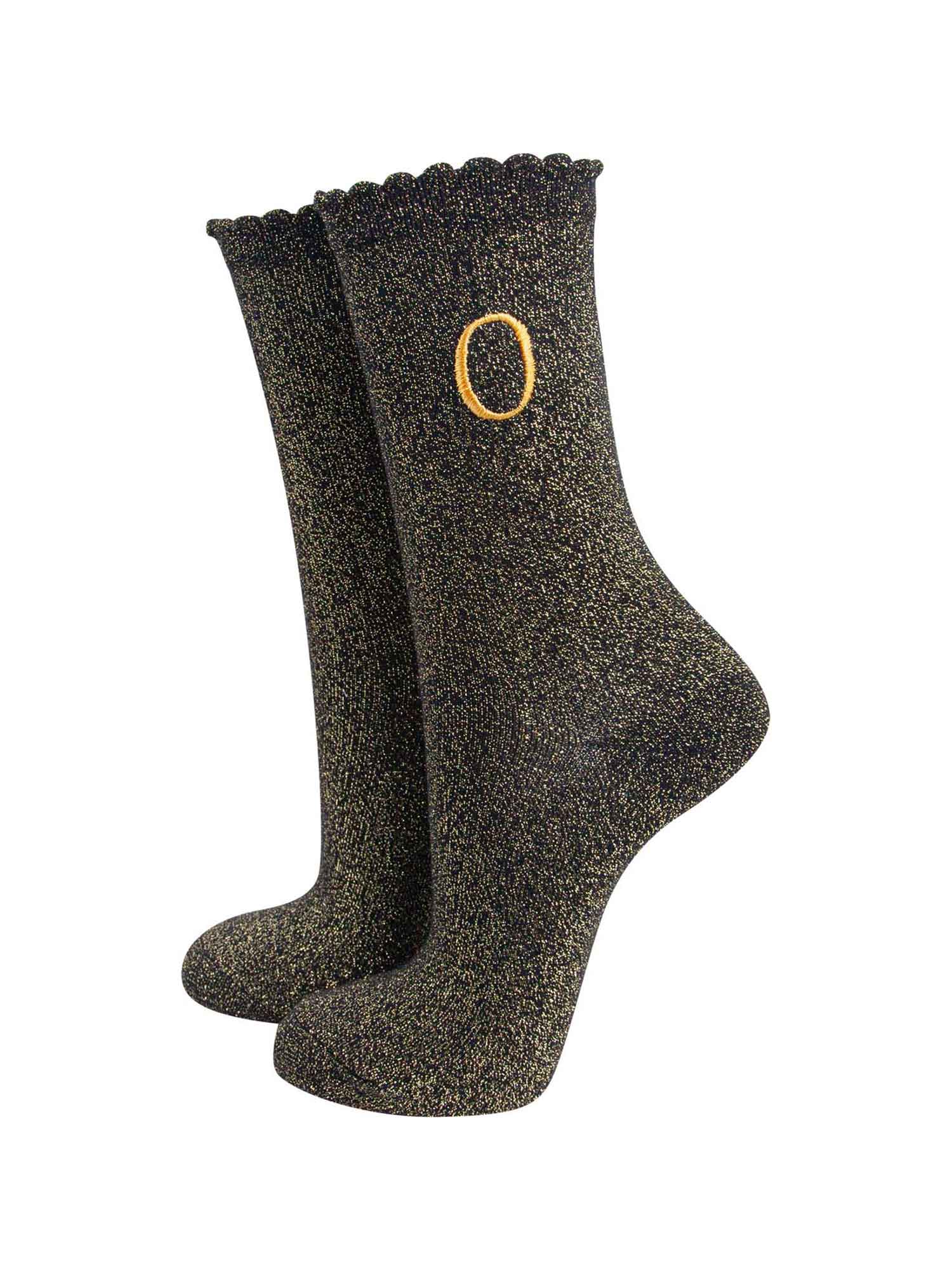 black ankle socks with a scalloped cuff, with an all over gold glitter sparkle and an embroidered gold letter o on the ankle