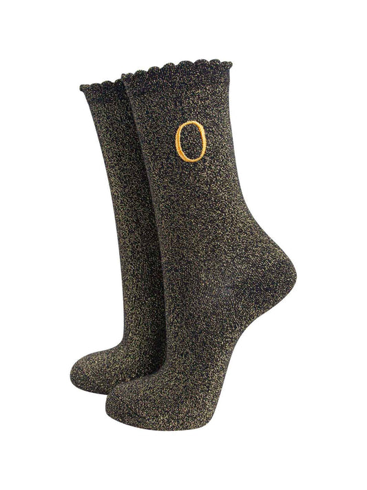 black ankle socks with a scalloped cuff, with an all over gold glitter sparkle and an embroidered gold letter o on the ankle