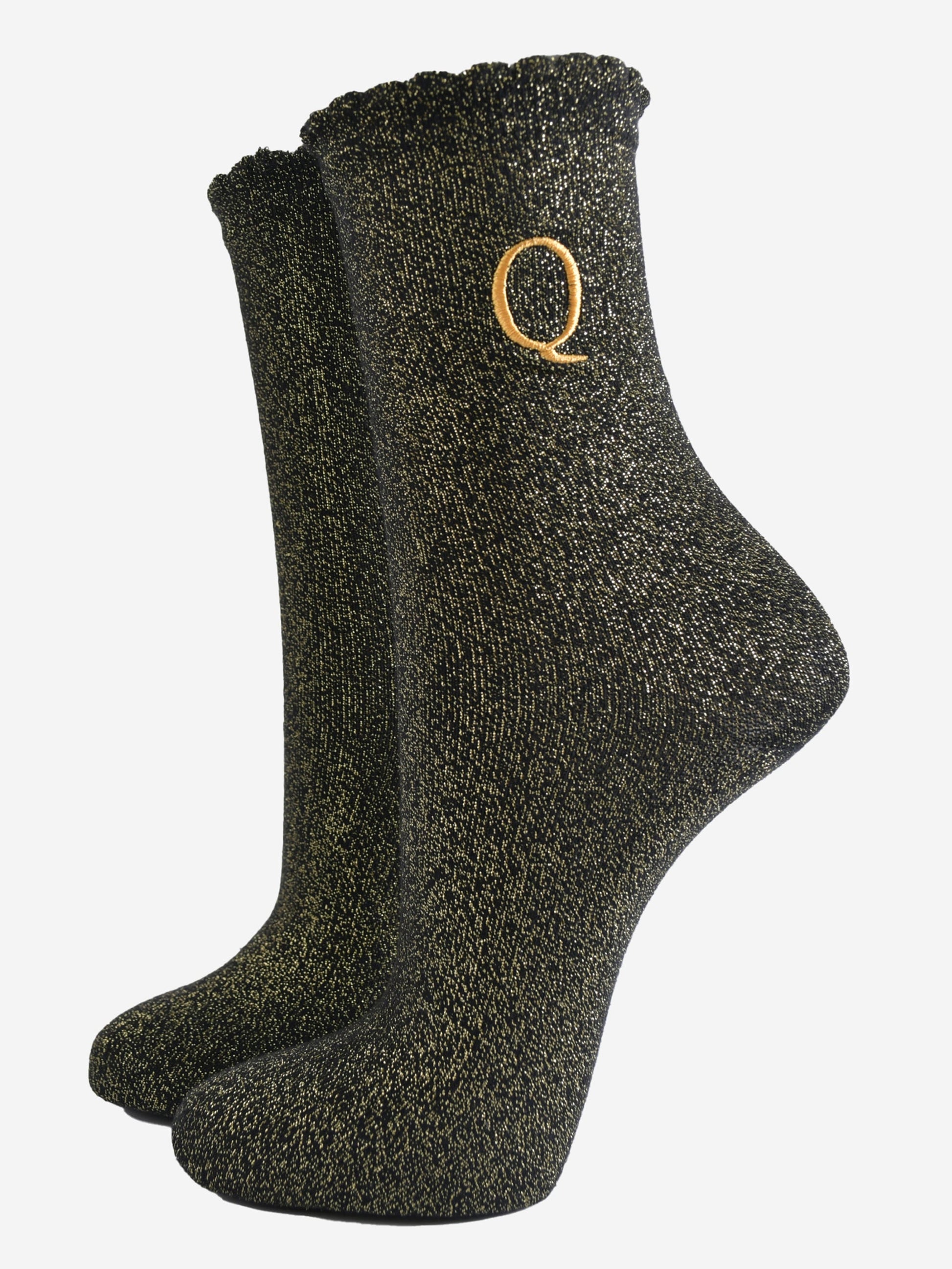 black ankle socks with a scalloped cuff, with an all over gold glitter sparkle and an embroidered gold letter q on the ankle