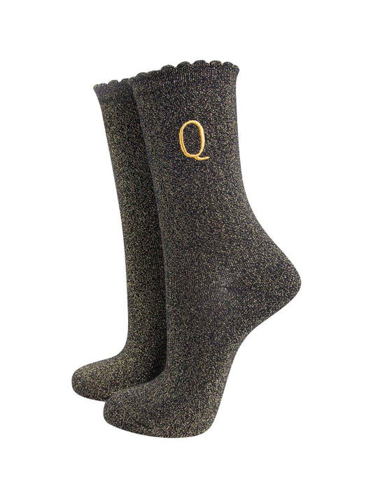 black ankle socks with a scalloped cuff, with an all over gold glitter sparkle and an embroidered gold letter q on the ankle