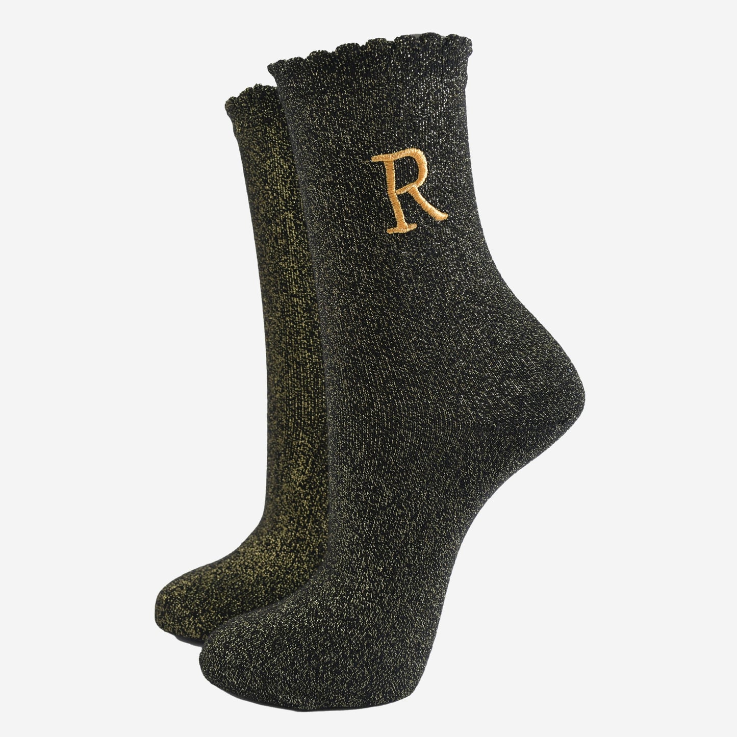 black ankle socks with a scalloped cuff, with an all over gold glitter sparkle and an embroidered gold letter r on the ankle