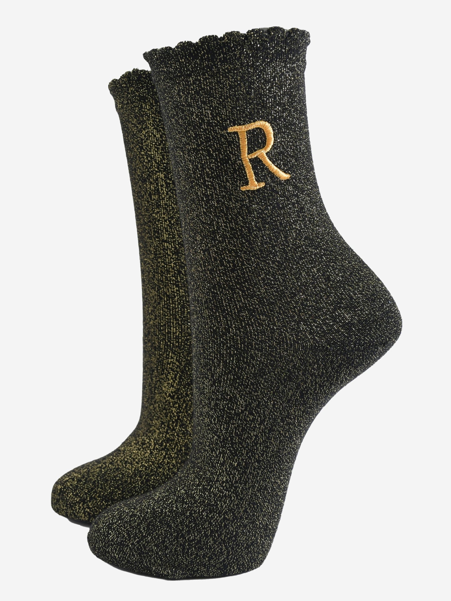 black ankle socks with a scalloped cuff, with an all over gold glitter sparkle and an embroidered gold letter r on the ankle