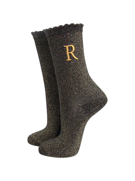 black ankle socks with a scalloped cuff, with an all over gold glitter sparkle and an embroidered gold letter on the ankle