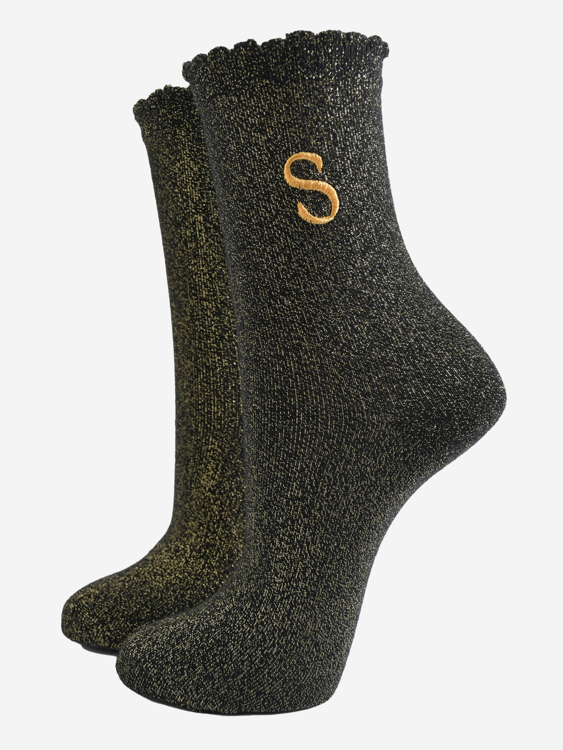 black ankle socks with a scalloped cuff, with an all over gold glitter sparkle and an embroidered gold letter s on the ankle