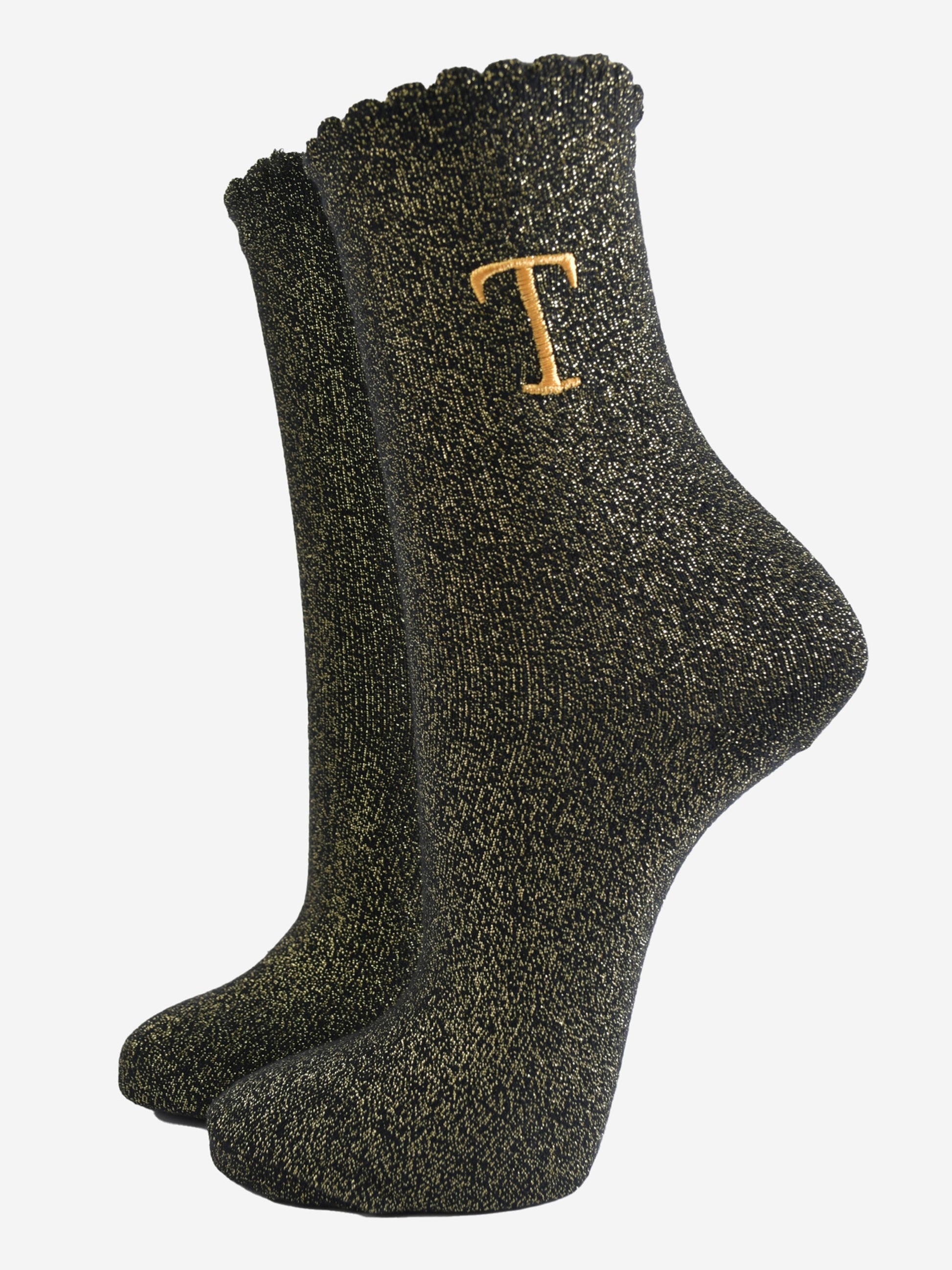 black ankle socks with a scalloped cuff, with an all over gold glitter sparkle and an embroidered gold letter t on the ankle