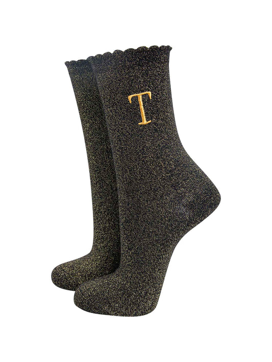 black ankle socks with a scalloped cuff, with an all over gold glitter sparkle and an embroidered gold letter t on the ankle