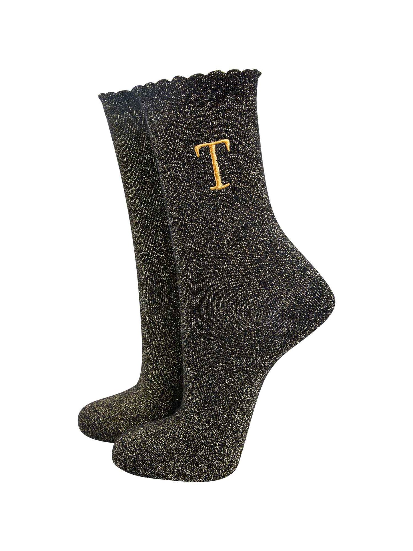 black ankle socks with a scalloped cuff, with an all over gold glitter sparkle and an embroidered gold letter t on the ankle
