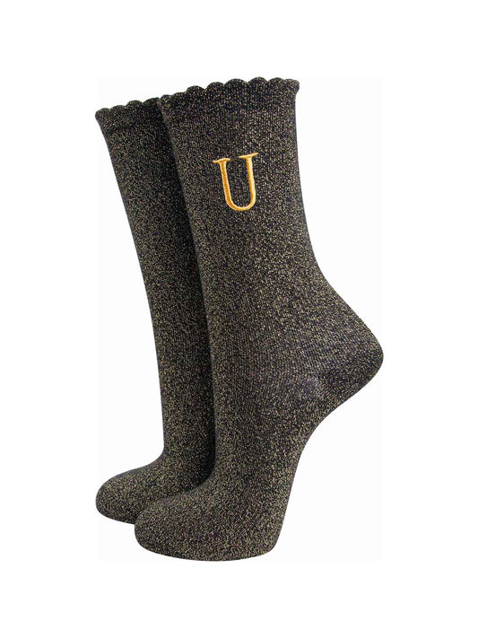 black ankle socks with a scalloped cuff, with an all over gold glitter sparkle and an embroidered gold letter u on the ankle
